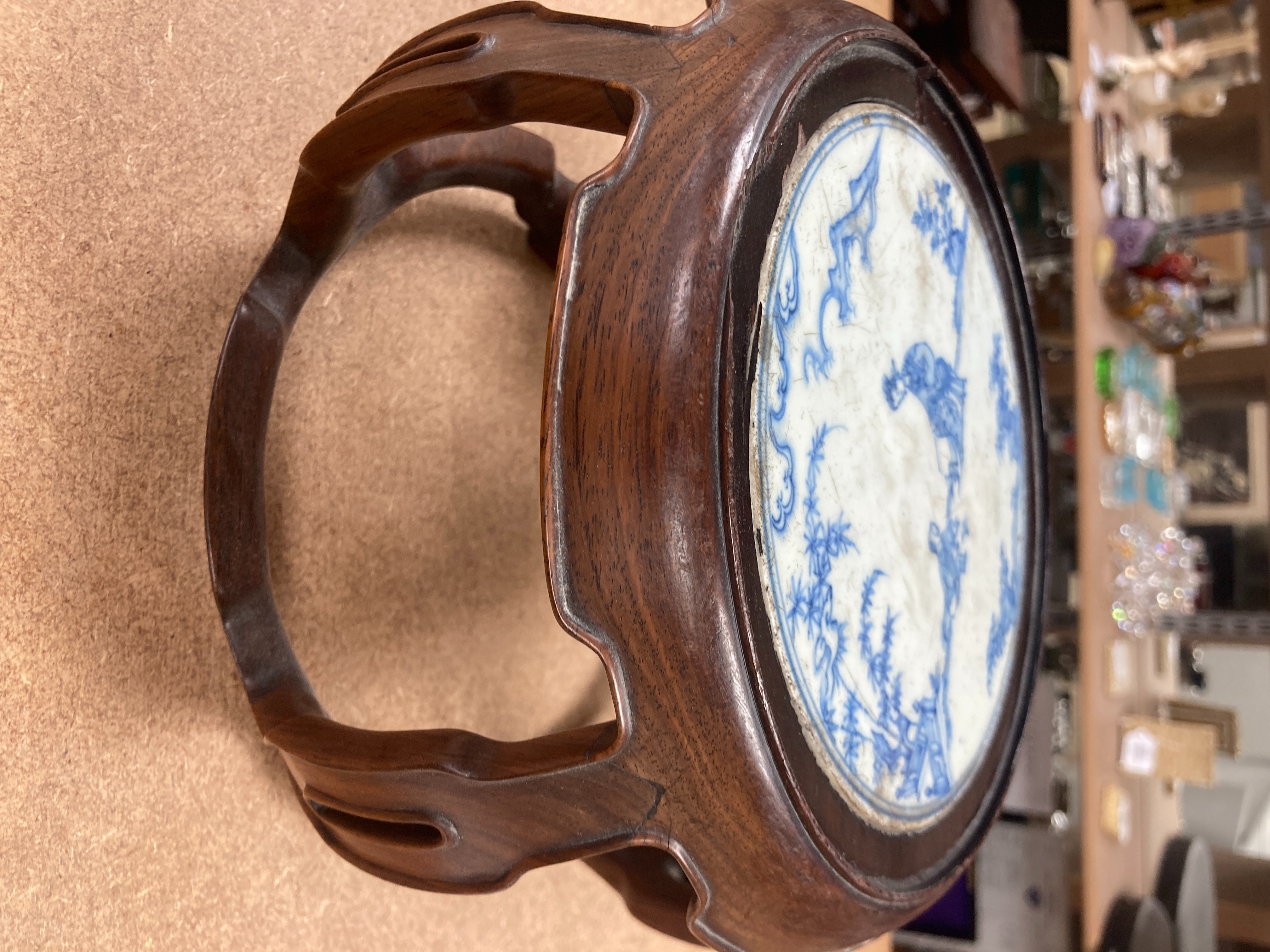 A 19th century Chinese blue and white circular tile inset hongmu stand, 22cm